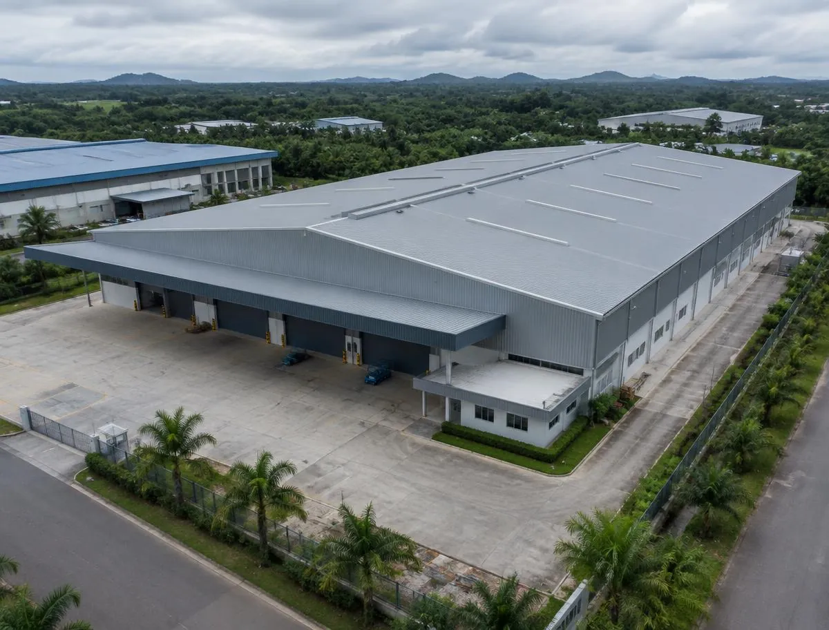 Aerial view of a large commercial building with a long-span metal roof